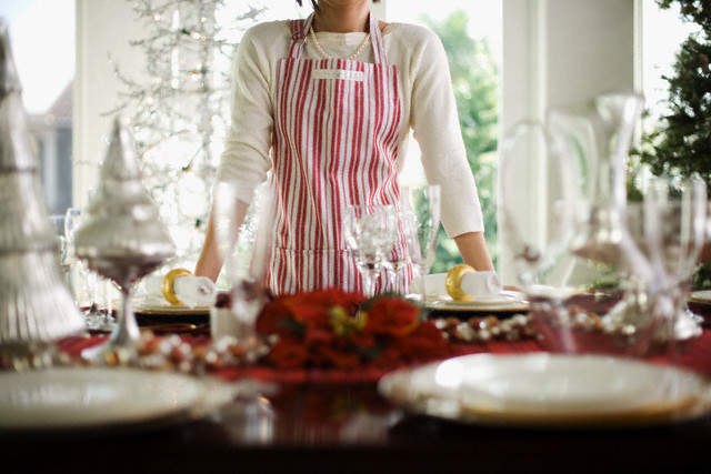 Woman Standing by Table Decorated for Christmas